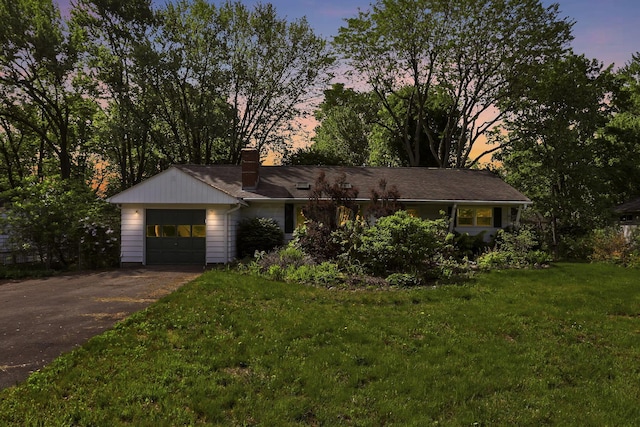 4648 E Johnstown Rd, Columbus, OH 43230 - single story home featuring asphalt driveway, a chimney, an attached garage, and a yard