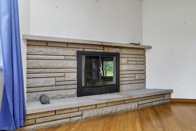 4648 E Johnstown Rd, Columbus, OH 43230 - detailed view of a stone fireplace, baseboards, and wood finished floors