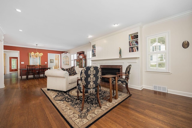 366 W S St, Worthington, OH 43085 - living room with dark wood-type flooring, a chandelier, a fireplace, ornamental molding, and recessed lighting