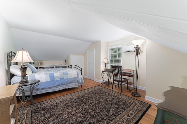 366 W S St, Worthington, OH 43085 - bedroom featuring lofted ceiling, wood finished floors, and a wall unit AC