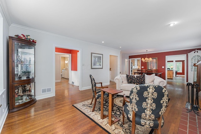 366 W S St, Worthington, OH 43085 - living room featuring a chandelier, wood finished floors, ornamental molding, and recessed lighting