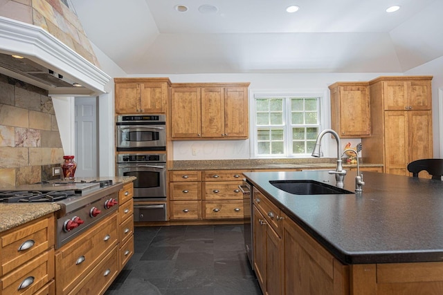 366 W S St, Worthington, OH 43085 - kitchen featuring appliances with stainless steel finishes, premium range hood, brown cabinets, a warming drawer, and a kitchen island with sink