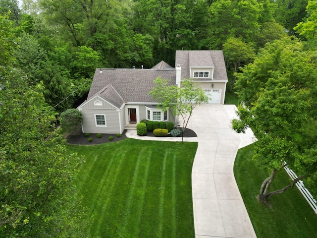 366 W S St, Worthington, OH 43085 - view of front of home with driveway, a front yard, roof with shingles, and a forest view