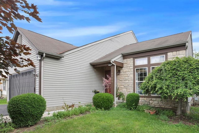4966 Brice Creek Dr, Canal Winchester, OH 43110 - ranch-style home with stone siding, an attached garage, and a shingled roof