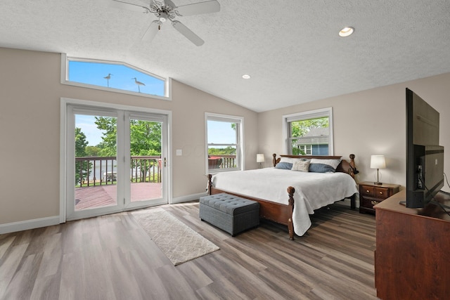1244 E Choctaw Dr, London, OH 43140 - bedroom with a textured ceiling, vaulted ceiling, access to outside, wood finished floors, and baseboards