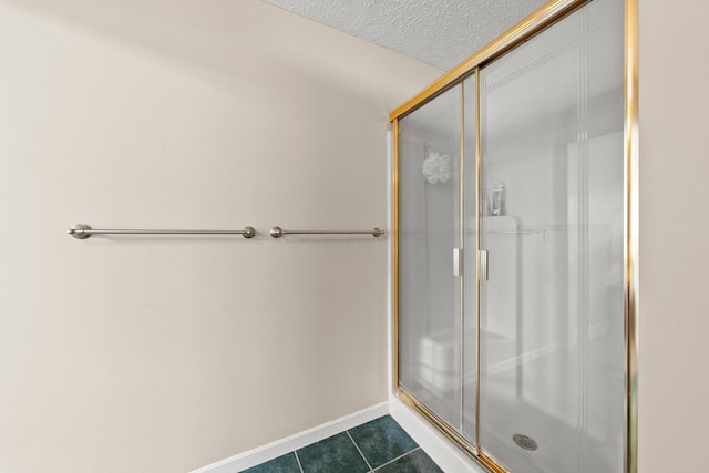 1244 E Choctaw Dr, London, OH 43140 - bathroom featuring a shower stall, tile patterned floors, baseboards, and a textured ceiling