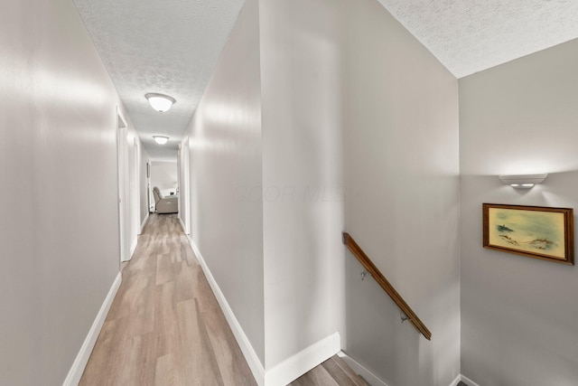 1244 E Choctaw Dr, London, OH 43140 - corridor with a textured ceiling, an upstairs landing, light wood-type flooring, and baseboards