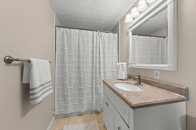 1244 E Choctaw Dr, London, OH 43140 - bathroom featuring tile patterned floors, vanity, curtained shower, a textured ceiling, and baseboards