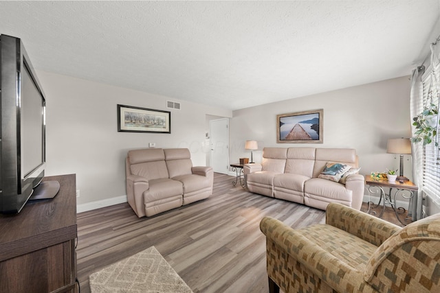 1244 E Choctaw Dr, London, OH 43140 - living room featuring wood finished floors, a textured ceiling, and baseboards