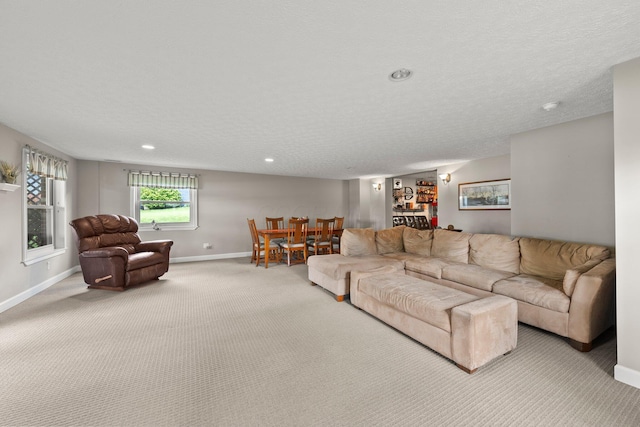 1244 E Choctaw Dr, London, OH 43140 - carpeted living area with baseboards, a textured ceiling, and recessed lighting