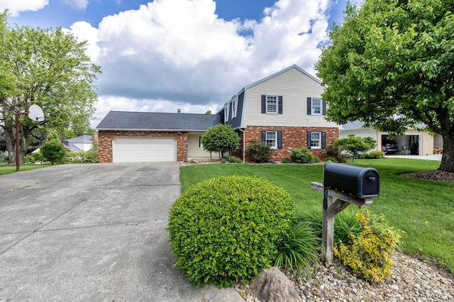 1541 Kensington Ln, Lancaster, OH 43130 - dutch colonial featuring brick siding, a garage, a front yard, and driveway