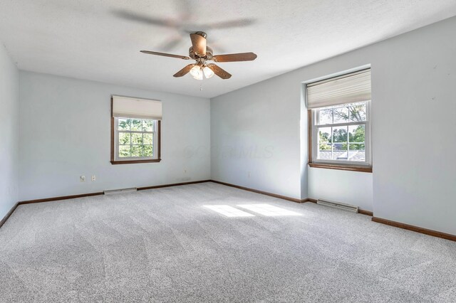 1541 Kensington Ln, Lancaster, OH 43130 - carpeted empty room featuring plenty of natural light, ceiling fan, and baseboards