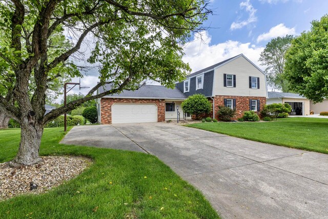 1541 Kensington Ln, Lancaster, OH 43130 - view of front of house with brick siding, concrete driveway, an attached garage, and a front lawn