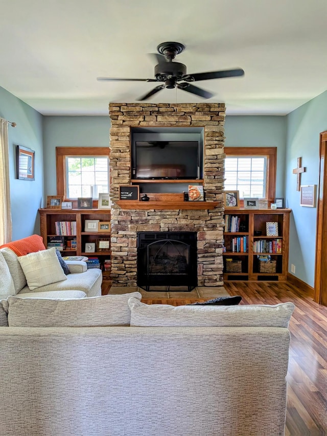 841 E Mulberry St, Lancaster, OH 43130 - living room with wood finished floors, ceiling fan, and a stone fireplace