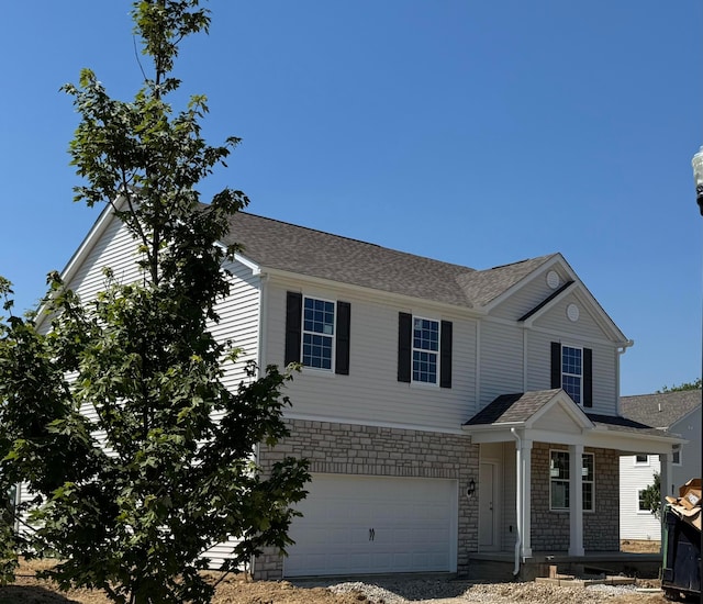 1283 Andean Dr Lot 69, Lockbourne, OH 43137 - view of front of property with stone siding, an attached garage, roof with shingles, and driveway