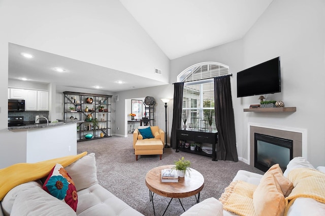 4481 Newport Loop E, Grove City, OH 43123 - carpeted living area with a glass covered fireplace, recessed lighting, baseboards, and high vaulted ceiling