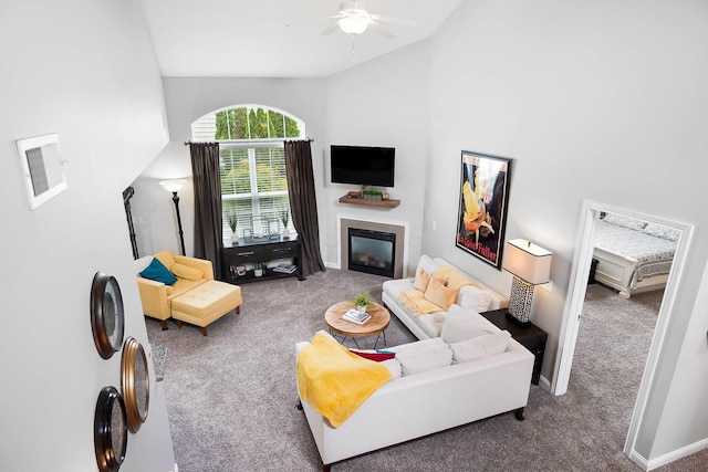 4481 Newport Loop E, Grove City, OH 43123 - living room with carpet floors, vaulted ceiling, a ceiling fan, and a glass covered fireplace