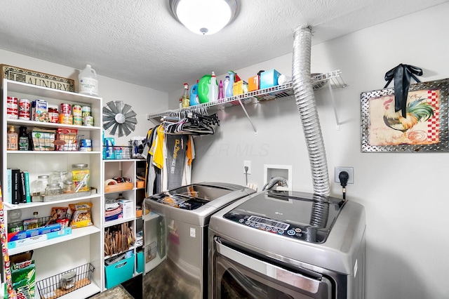 4481 Newport Loop E, Grove City, OH 43123 - laundry room featuring washing machine and dryer and a textured ceiling