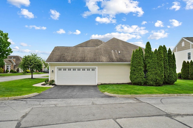 4481 Newport Loop E, Grove City, OH 43123 - view of side of home with driveway, an attached garage, a lawn, and roof with shingles