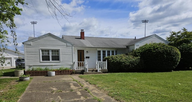 36 Johnson Rd, The Plains, OH 45780 - view of front of home with a front lawn and a chimney