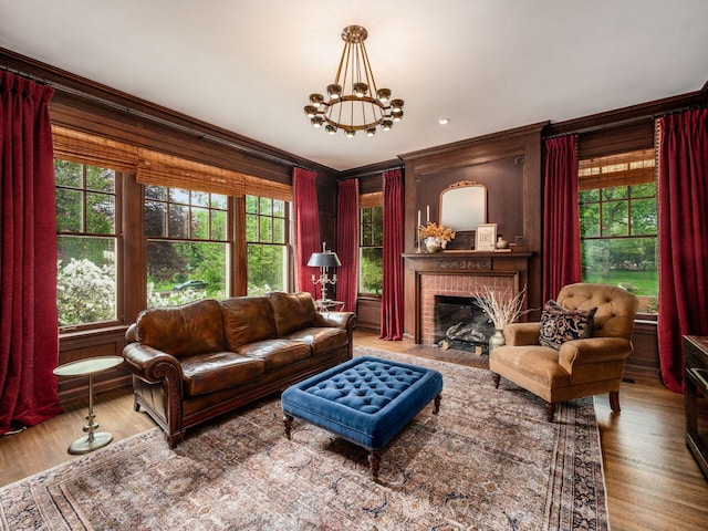 140 N Parkview Ave, Bexley, OH 43209 - living room featuring ornamental molding, wood finished floors, a fireplace, and a chandelier