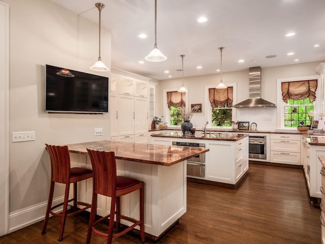 140 N Parkview Ave, Bexley, OH 43209 - kitchen featuring wall chimney exhaust hood, a peninsula, stainless steel oven, dark wood-style flooring, and recessed lighting