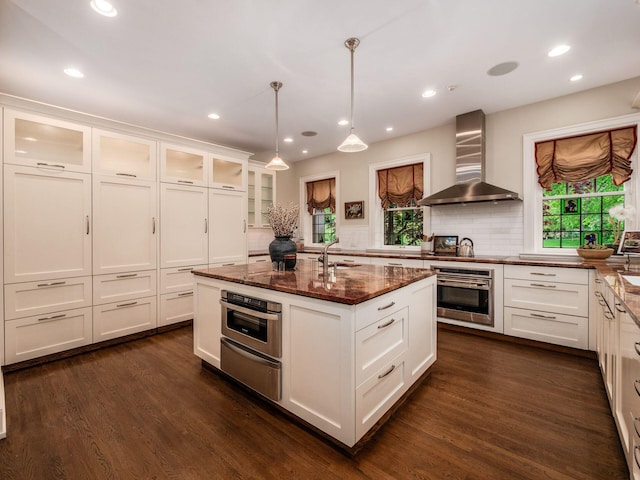140 N Parkview Ave, Bexley, OH 43209 - kitchen featuring stainless steel oven, wall chimney range hood, a warming drawer, plenty of natural light, and recessed lighting