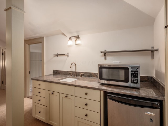 140 N Parkview Ave, Bexley, OH 43209 - kitchen with stainless steel microwave, a sink, refrigerator, cream cabinets, and dark stone counters