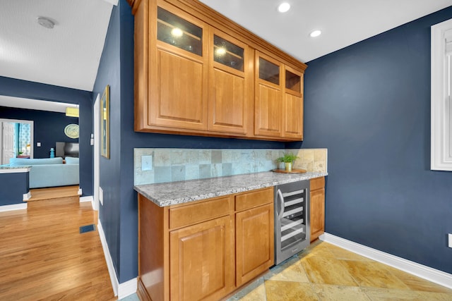 609 Mohawk St, Columbus, OH 43206 - bar area with wine cooler, baseboards, light wood-style flooring, recessed lighting, and decorative backsplash