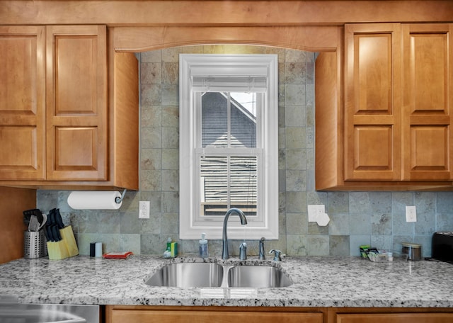 609 Mohawk St, Columbus, OH 43206 - kitchen featuring a sink, light stone countertops, and backsplash