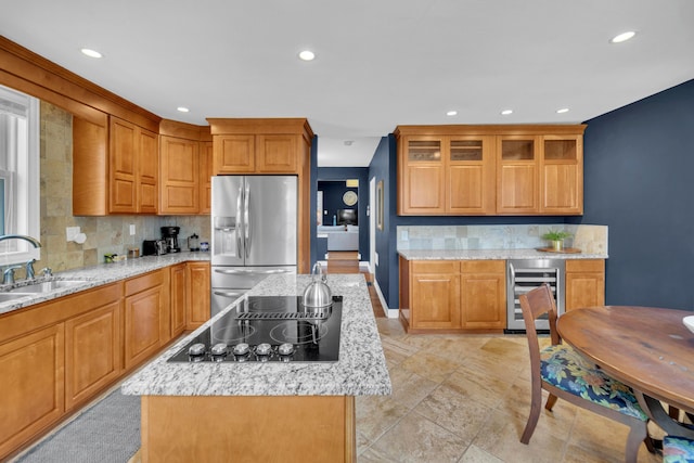 609 Mohawk St, Columbus, OH 43206 - kitchen featuring beverage cooler, stainless steel fridge with ice dispenser, black electric stovetop, a kitchen island, and decorative backsplash