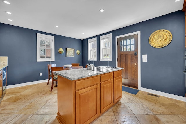 609 Mohawk St, Columbus, OH 43206 - kitchen featuring electric cooktop, baseboards, stone tile flooring, light stone countertops, and recessed lighting