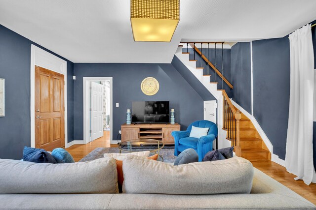 609 Mohawk St, Columbus, OH 43206 - living area featuring stairway, wood finished floors, and baseboards
