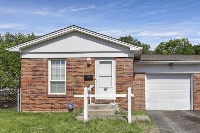 1950-1952 Bairsford Dr, Columbus, OH 43232 - view of front of home featuring brick siding, a garage, fence, and asphalt driveway