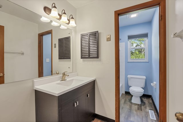 1950-1952 Bairsford Dr, Columbus, OH 43232 - bathroom featuring toilet, vanity, wood finished floors, baseboards, and a tub