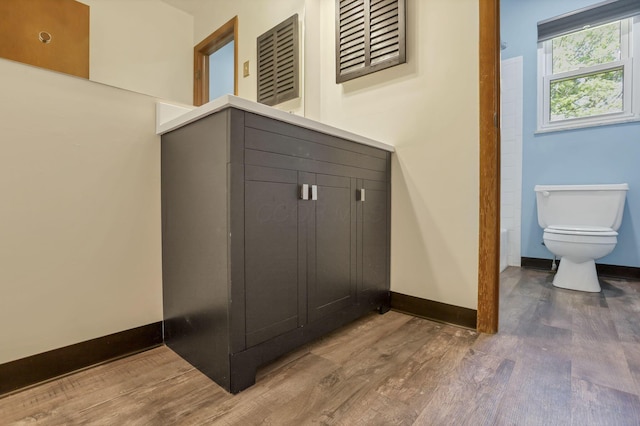 1950-1952 Bairsford Dr, Columbus, OH 43232 - bathroom featuring wood finished floors, toilet, and baseboards