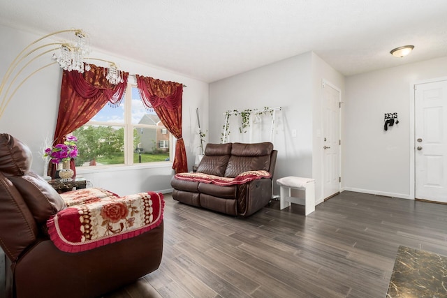 living area with wood finished floors and baseboards