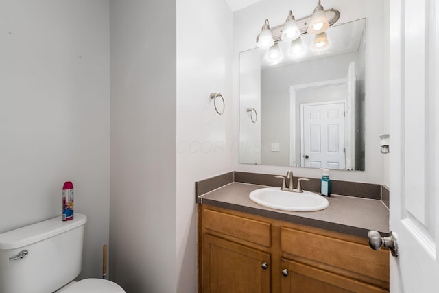 bathroom with toilet and vanity