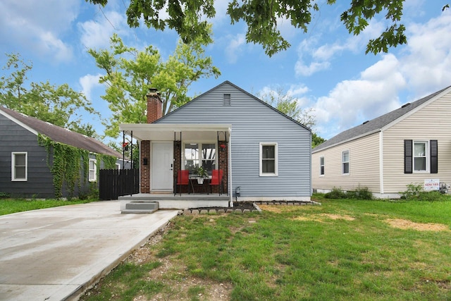 523 S Napoleon Ave, Columbus, OH 43213 - rear view of house featuring a chimney, a porch, and a lawn
