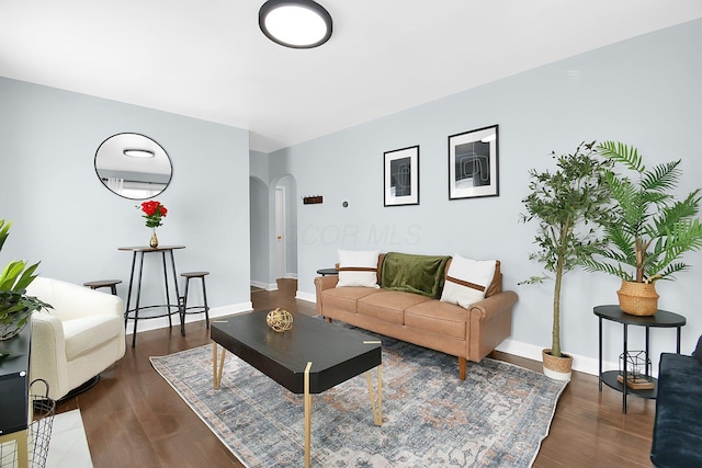 523 S Napoleon Ave, Columbus, OH 43213 - living room featuring arched walkways, wood finished floors, and baseboards
