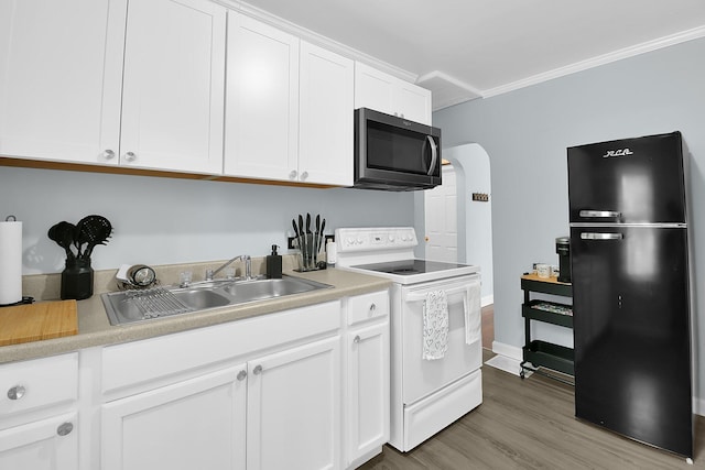 523 S Napoleon Ave, Columbus, OH 43213 - kitchen featuring freestanding refrigerator, white range with electric cooktop, stainless steel microwave, a sink, and white cabinetry