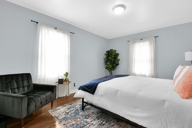 523 S Napoleon Ave, Columbus, OH 43213 - bedroom featuring multiple windows, wood finished floors, and baseboards