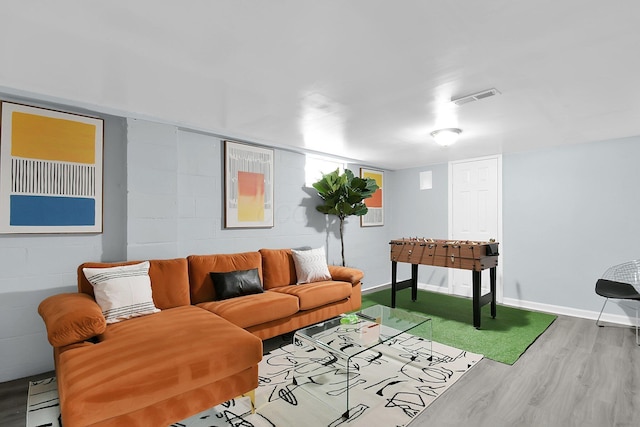 523 S Napoleon Ave, Columbus, OH 43213 - living area with wood finished floors, concrete block wall, and baseboards