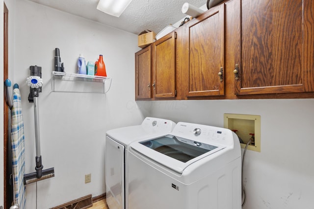 214 Sylvan Dr, Delaware, OH 43015 - washroom featuring washing machine and dryer, cabinet space, and a textured ceiling