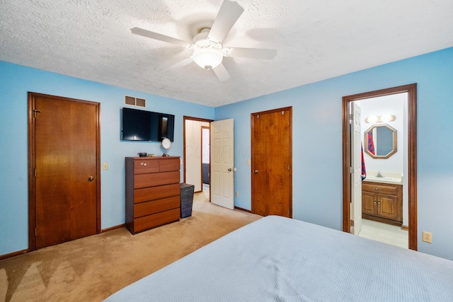 214 Sylvan Dr, Delaware, OH 43015 - bedroom featuring light colored carpet, a closet, baseboards, a textured ceiling, and ensuite bathroom
