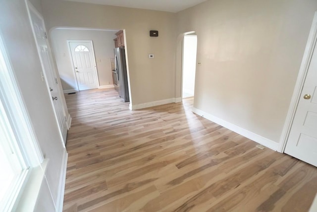 723 N Maple St, Lancaster, OH 43130 - hall featuring arched walkways, light wood-style floors, and baseboards