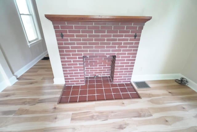 723 N Maple St, Lancaster, OH 43130 - detailed view of a fireplace with flush hearth, wood finished floors, and baseboards