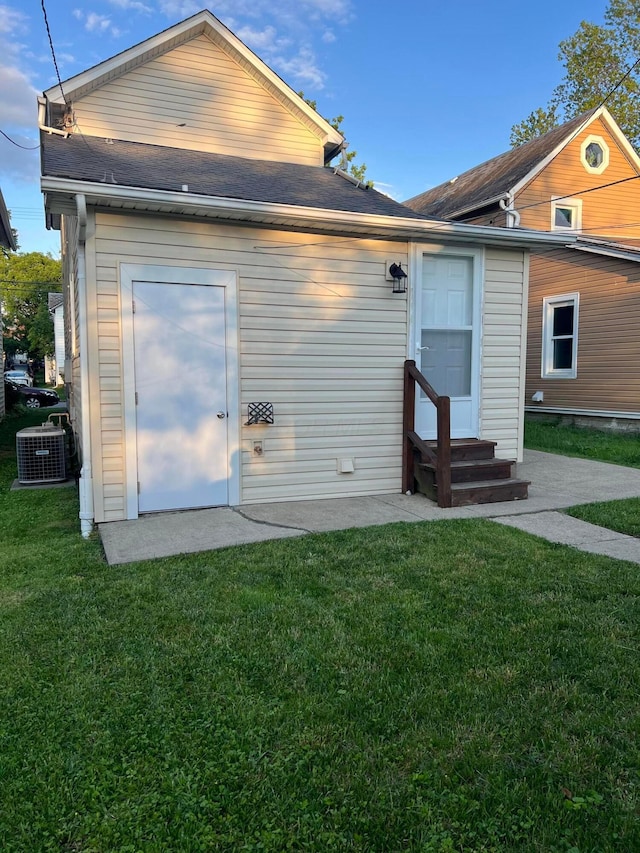 723 N Maple St, Lancaster, OH 43130 - back of property with entry steps, a yard, central air condition unit, and roof with shingles
