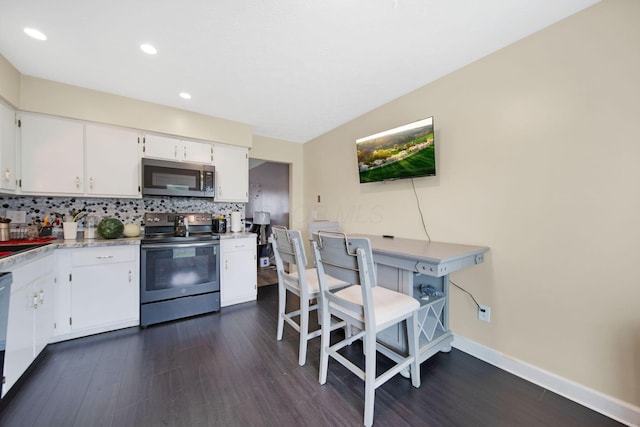 5309 Trillium Ct, Columbus, OH 43230 - kitchen featuring appliances with stainless steel finishes, dark wood-type flooring, light countertops, white cabinets, and recessed lighting