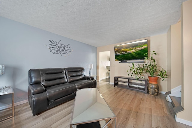 5309 Trillium Ct, Columbus, OH 43230 - living room featuring wood finished floors, baseboards, and a textured ceiling